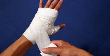 boxer using hand wraps before training