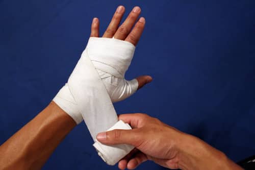 boxer using hand wraps before training